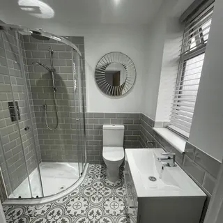 Compact bathroom refurbishment with bath and shower screen