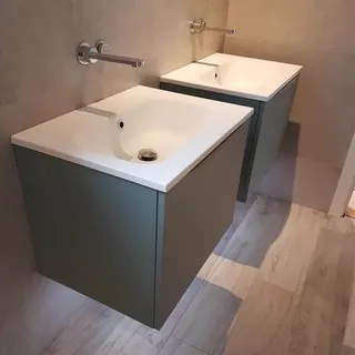 Double basin vanity with mirrors and wall lighting