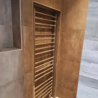 Wall-mounted towel radiator in a bathroom