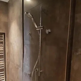 Walk-in shower with glass screen and tiled walls