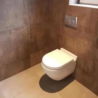 Toilet installation with tiled wall finish