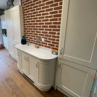 Kitchen installation with fitted units and tiled splashback